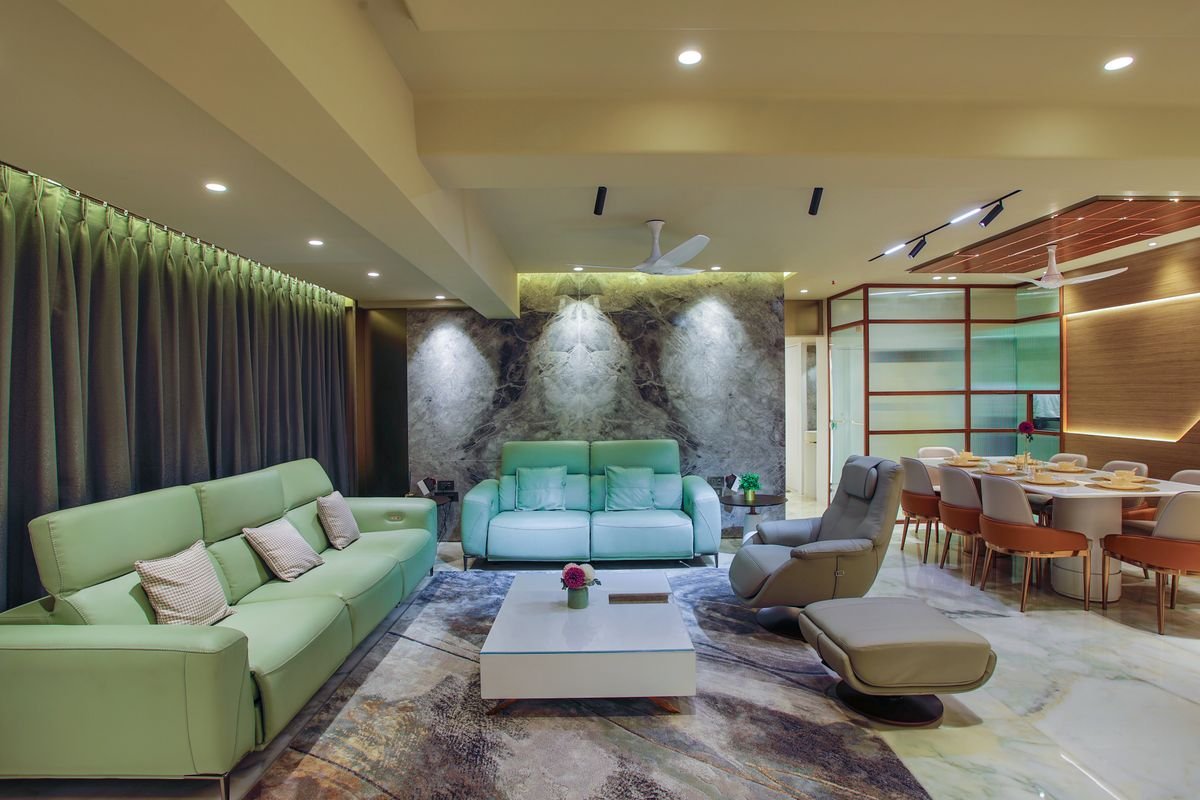 Elegant living room designed with layered lighting and soft green accents