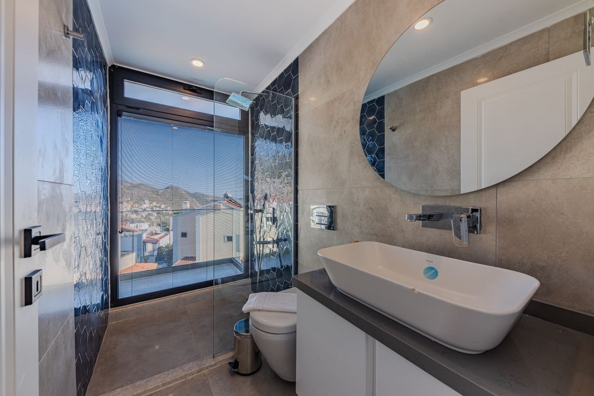 Window-View Bathroom with Freestanding Tub and Oval Mirror
