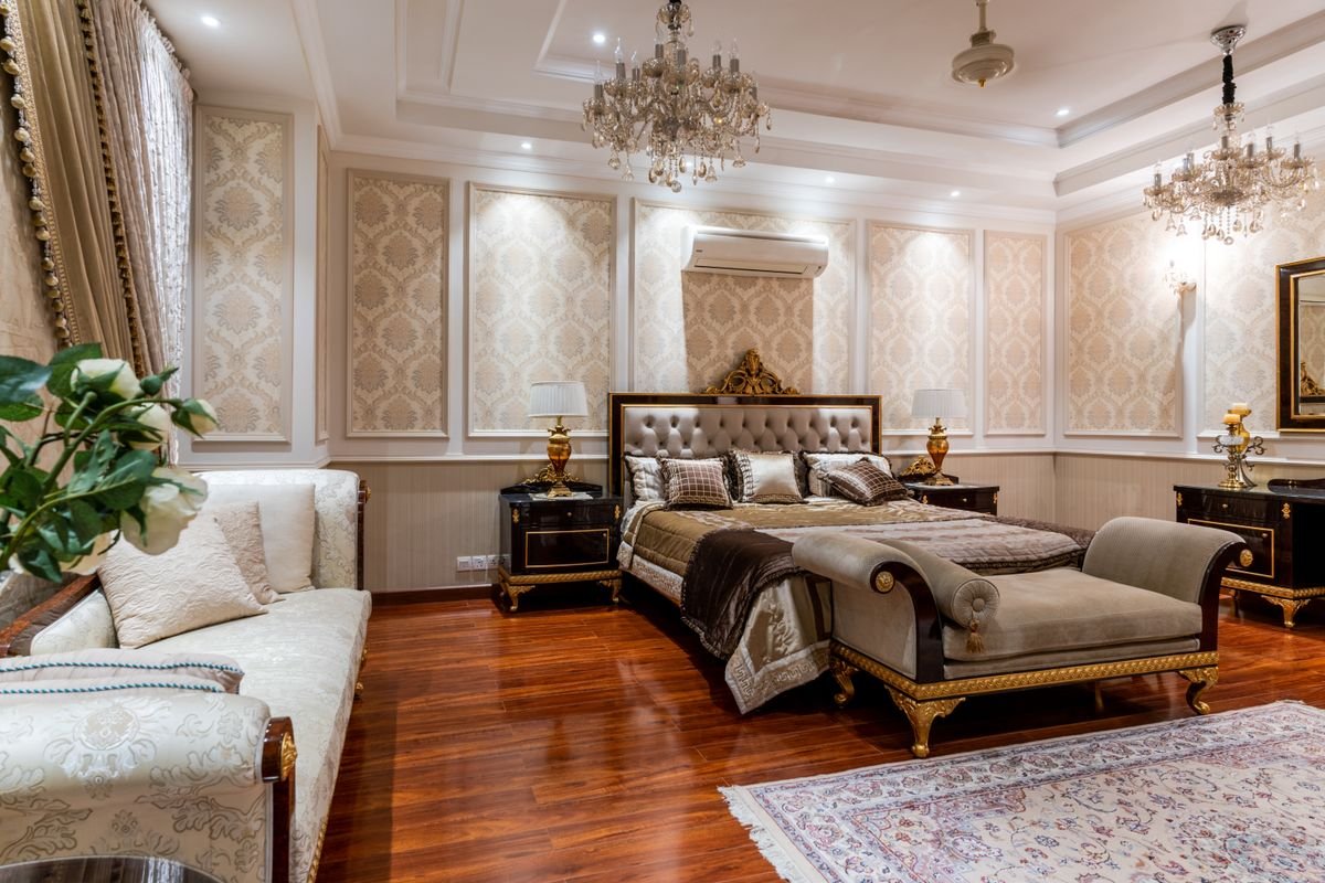 Classic Master Bedroom with Crystal Chandeliers and Chaise Lounge