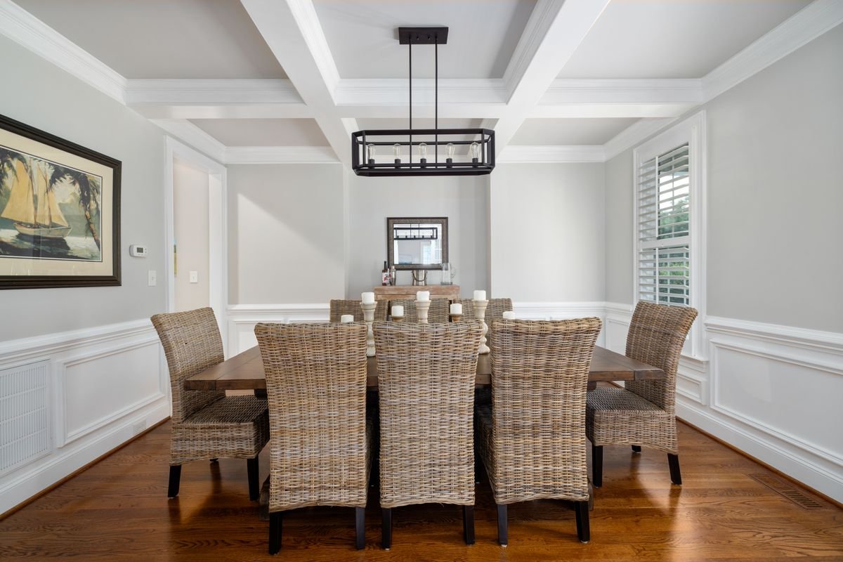 White Coffered Ceiling with Linear Pendant over the Dining Table
