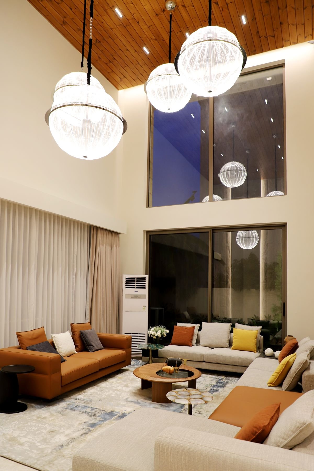 Wooden Panel Ceiling with Crystal Pendants in a Double-Height Living Room