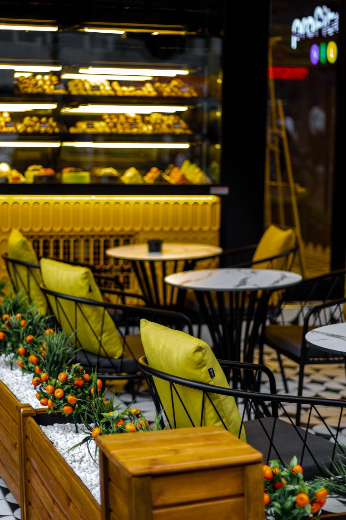 Vibrant Yellow Bakery Caf&eacute; with Citrus Planters