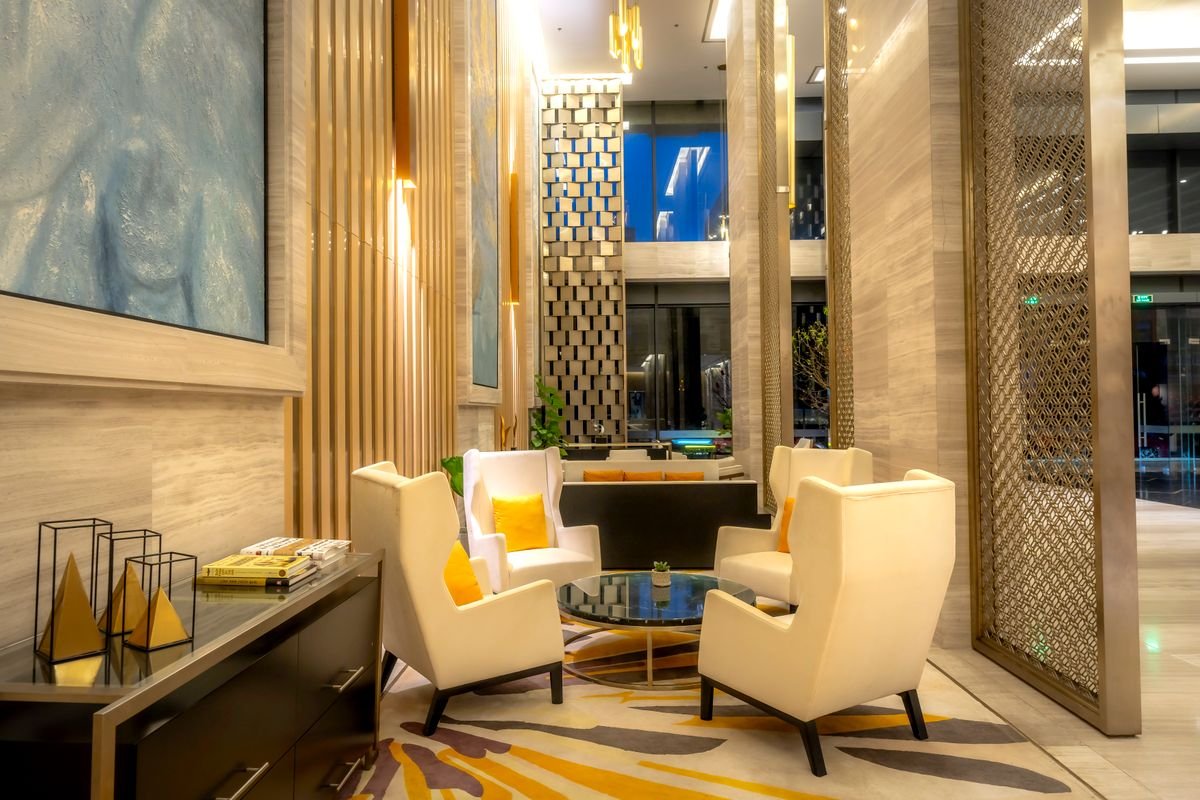 Luxury Gold-Accented Lobby Nook with Geometric Metal Screen