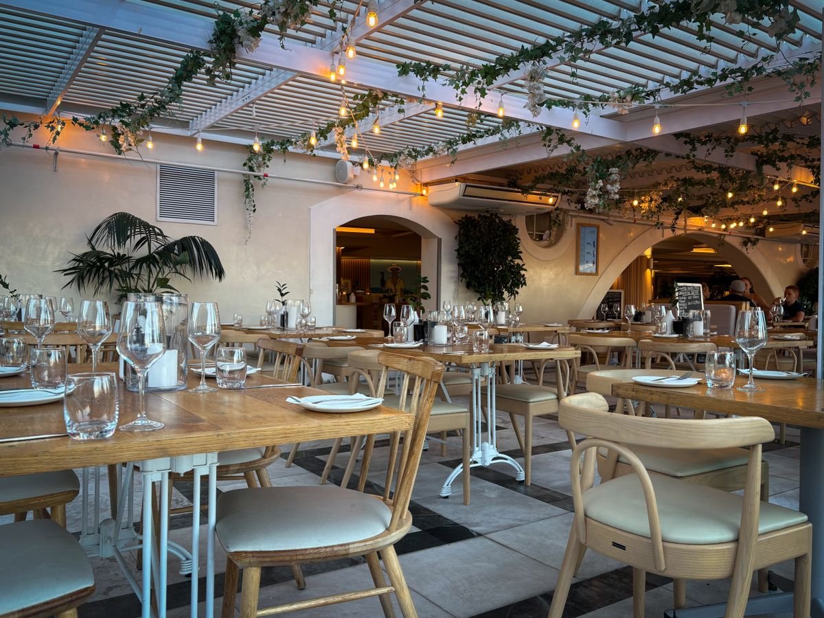 Pergola-Covered Terrace Restaurant with String Lights and Greenery