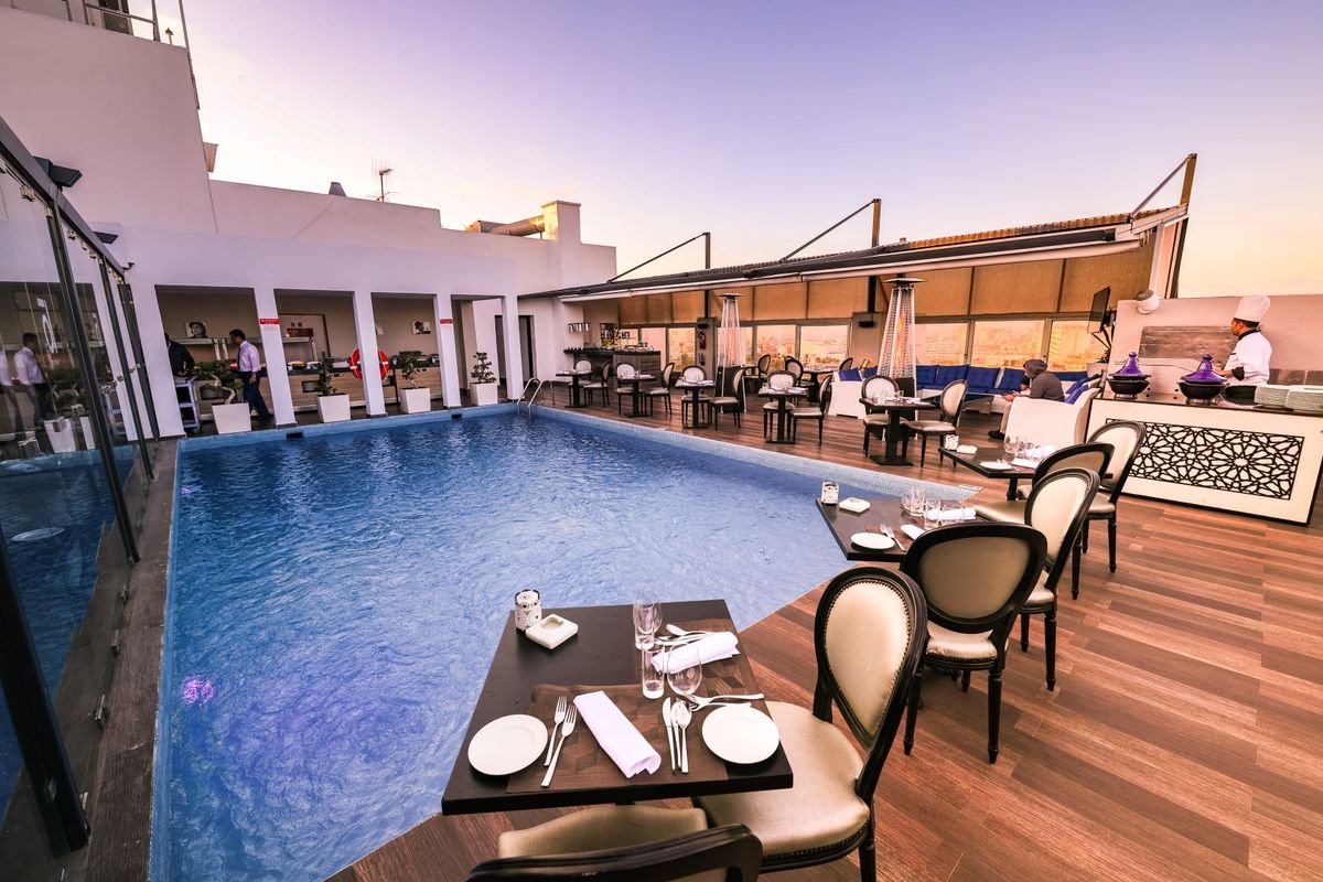 Poolside Rooftop Restaurant at Sunset with Elegant Seating
