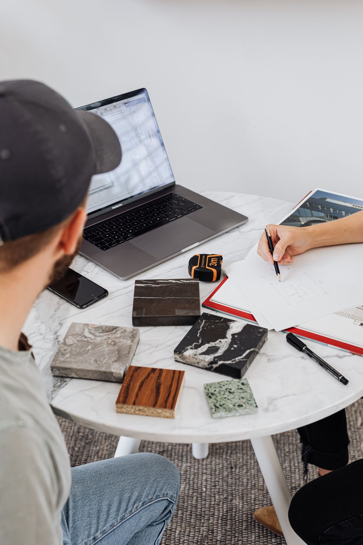 Designers comparing wood, stone and fabric material samples