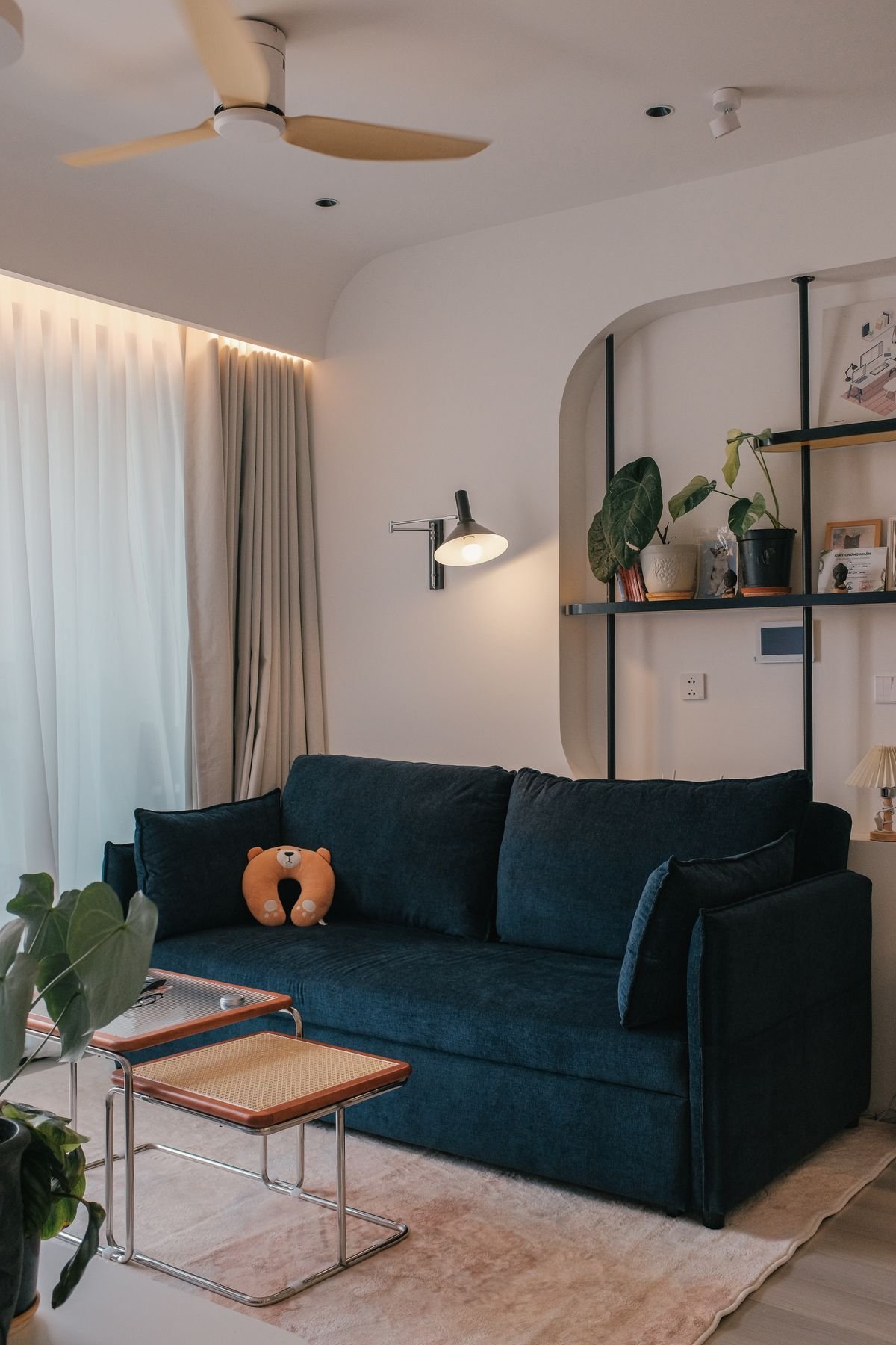 Modern living room with dark sofa and soft daylight