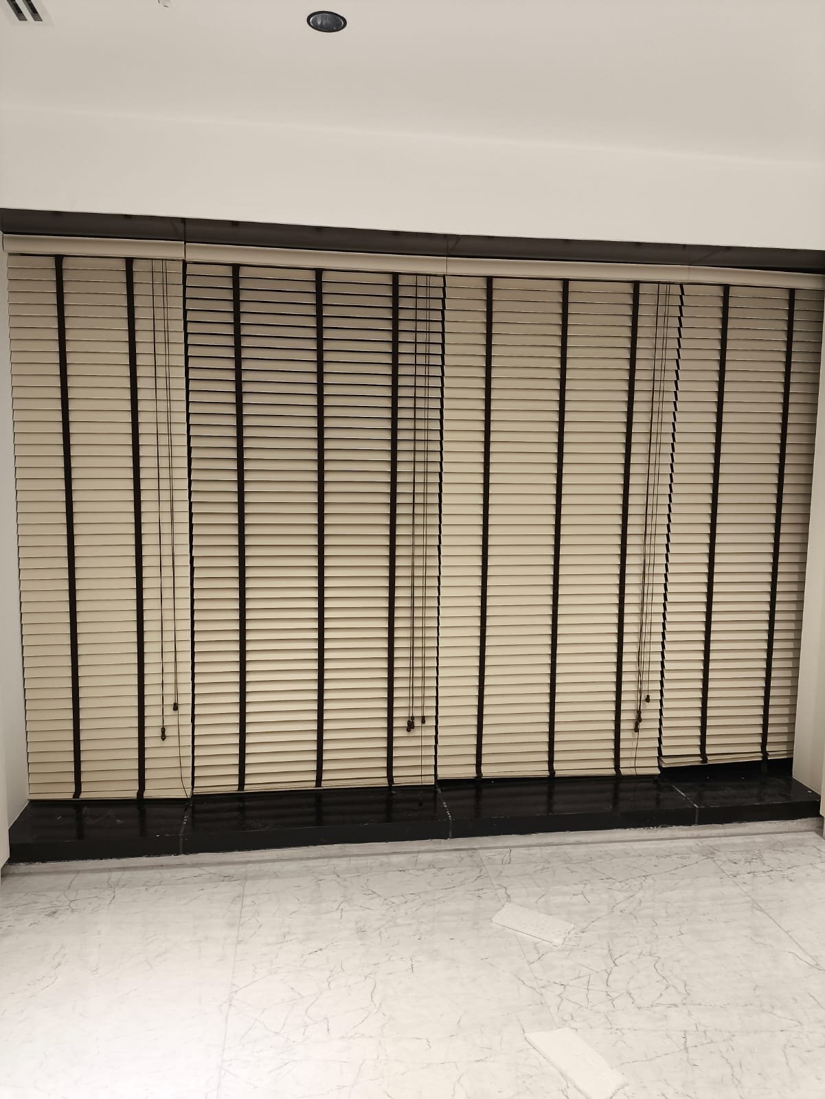 Beige Venetian Blinds Over a Marble Floor