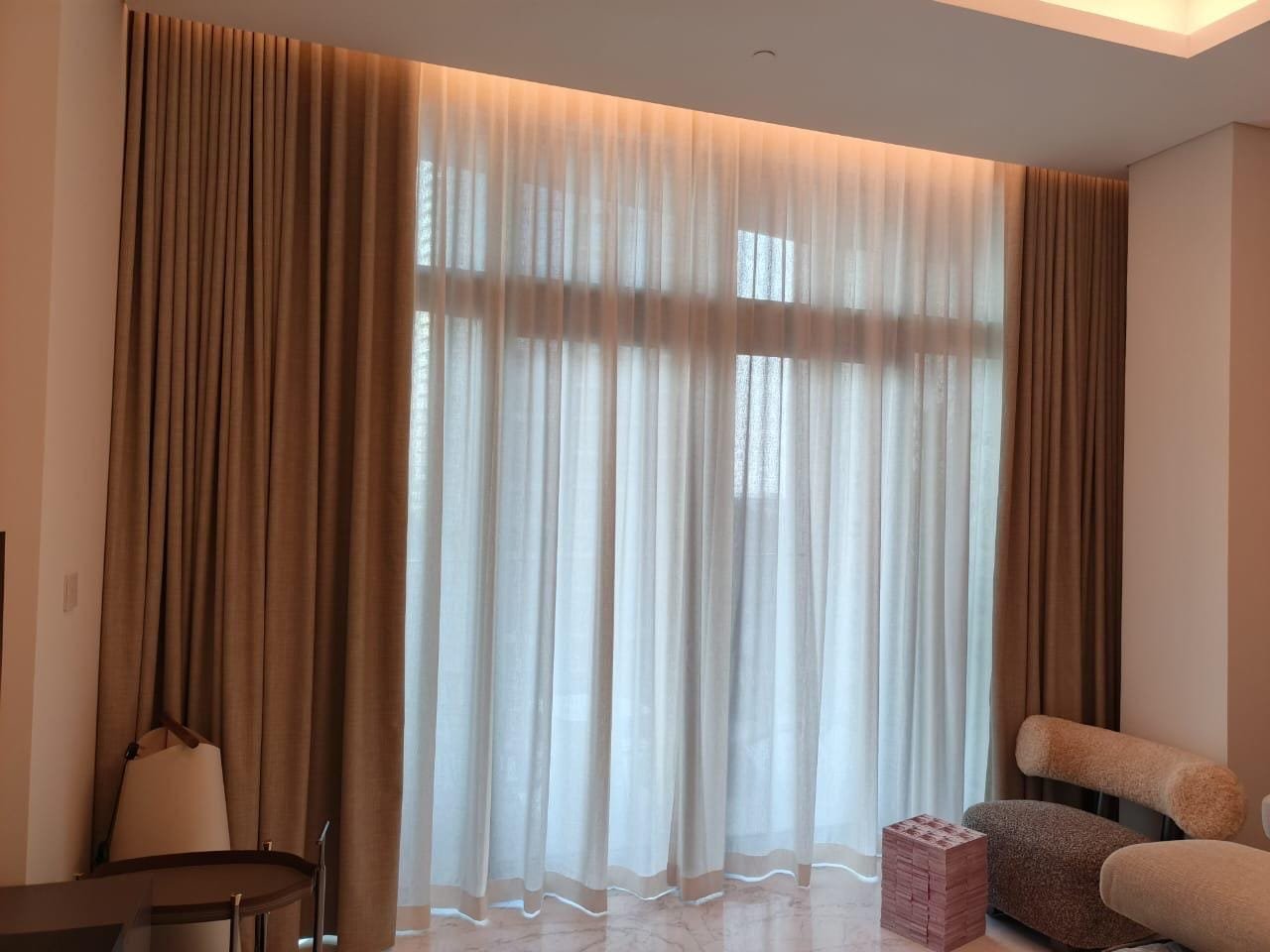 Sheer Wave Curtains with Cove Lighting in a Living Room