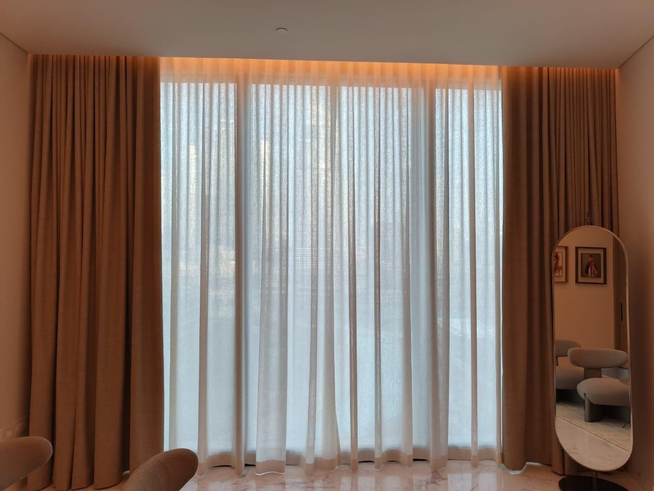 Layered Sheer Curtains Beside a Dressing Mirror