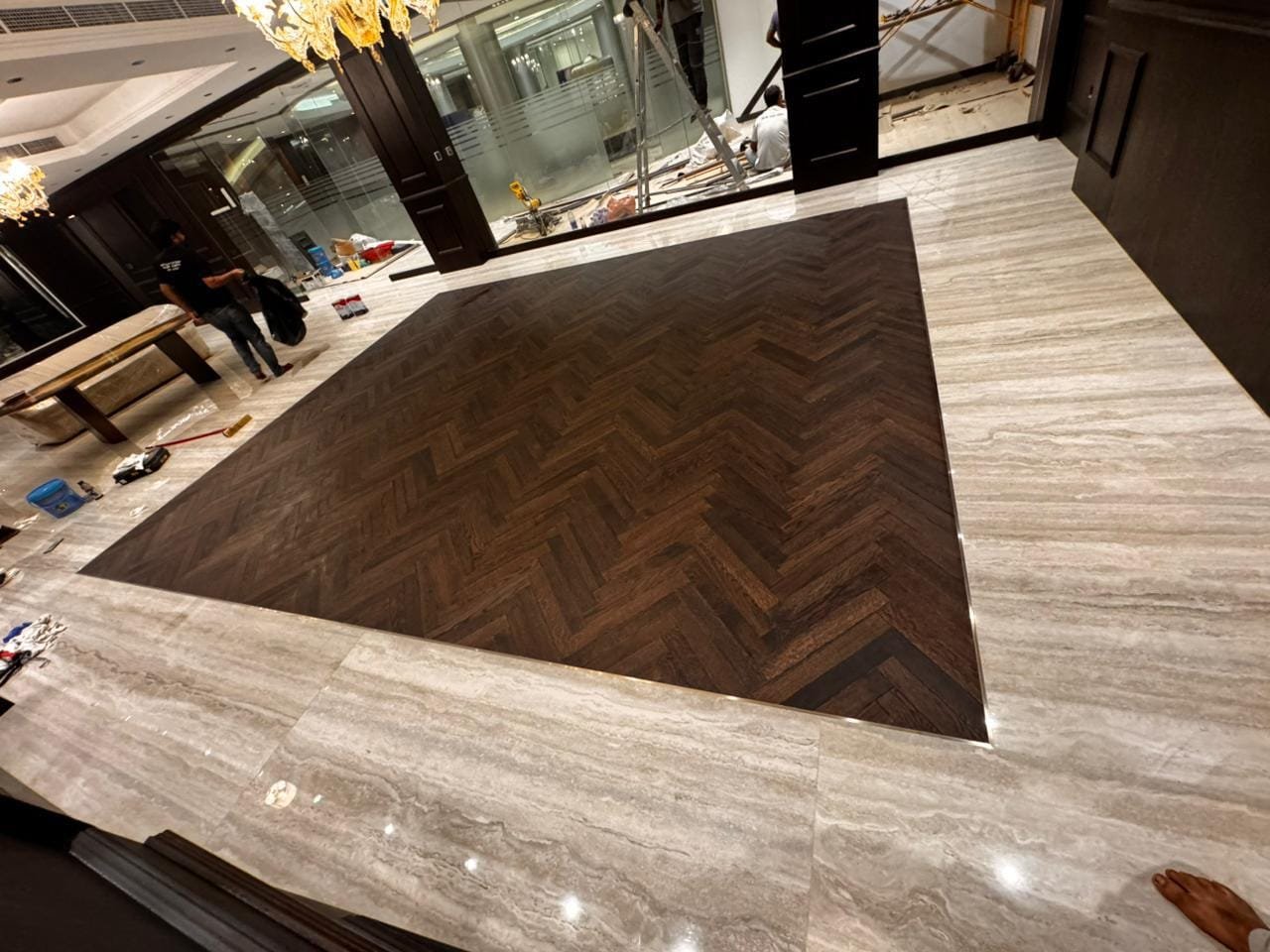 Herringbone Wood Inlay Set into a Marble Floor
