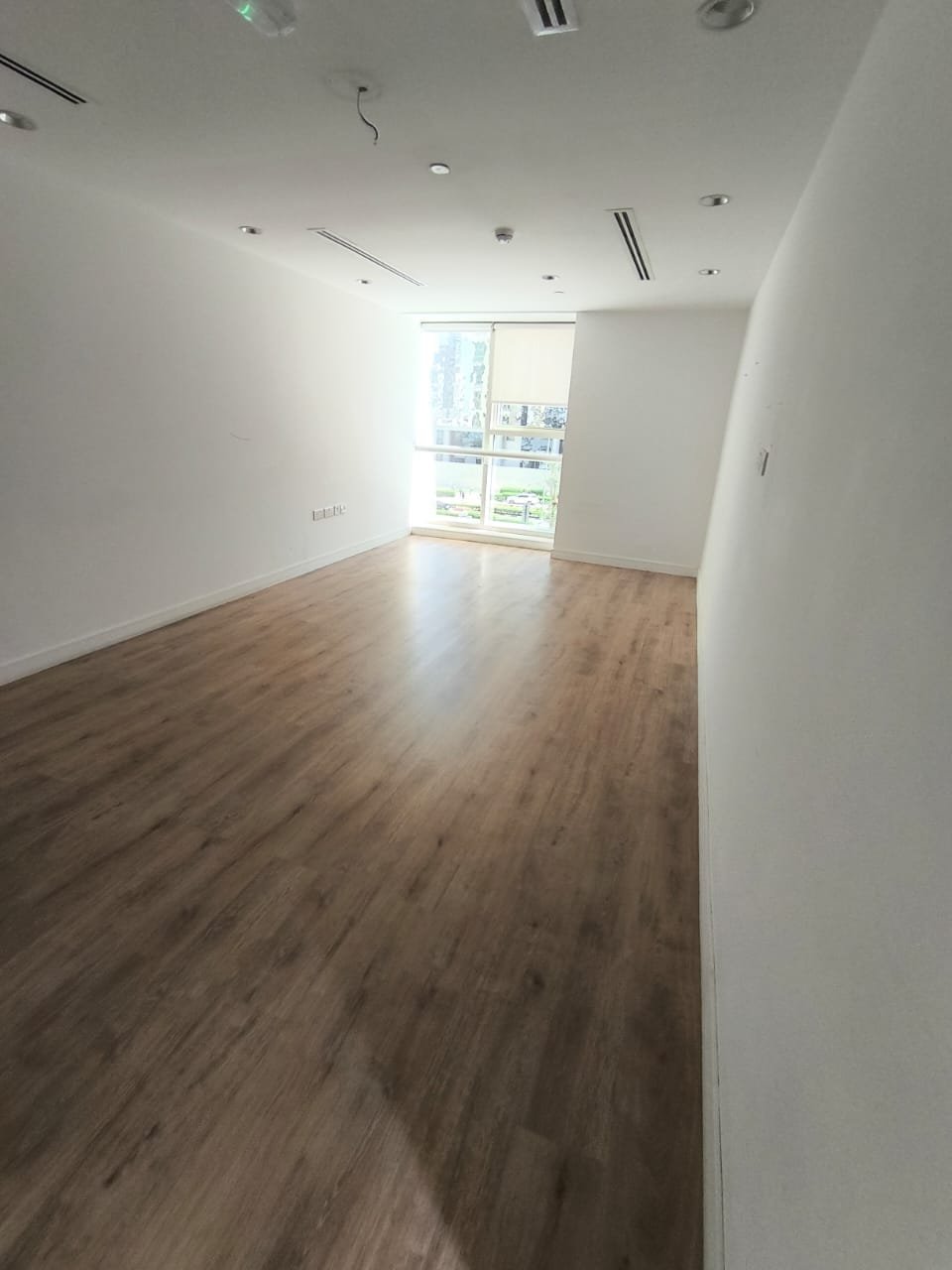 Finished Dark Wood-Tone Flooring in a Sunlit Room